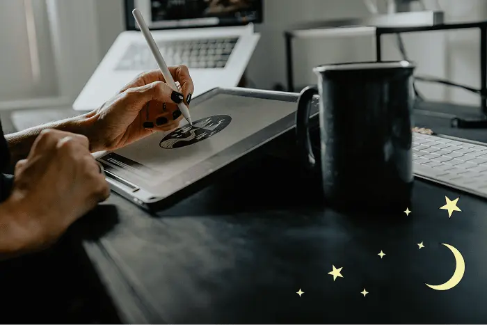 image of designer drawing on ipad with coffee cup off to the side